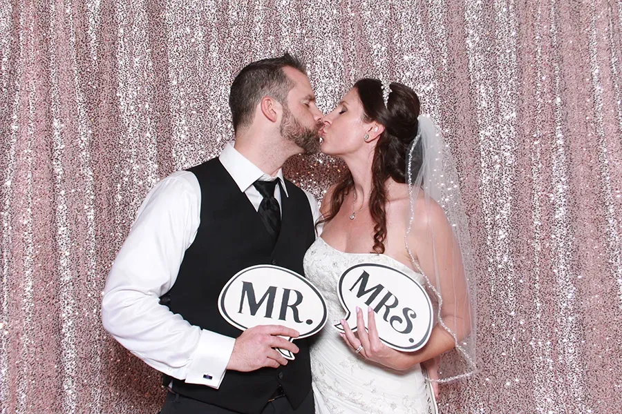 Wedding reception glam booth portrait with editorial flash styling.
