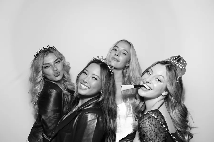 Stylish party guests enjoying a modern glam photo booth portrait.